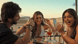 Cocktail 2 cast enjoying a rooftop dinner in Sicily, scene from the film - cocktail 2 review reddit