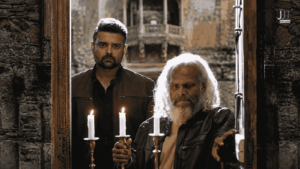Mimoh Chakraborty and a white-haired older man holding candles inside a crumbling stone haveli doorway in a still from Haunted 3D Echoes of the Past
