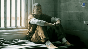 Who kidnapped Matthew in I Will Find You Netflix - Sam Worthington as David Burroughs sitting alone in his prison cell staring out the barred window