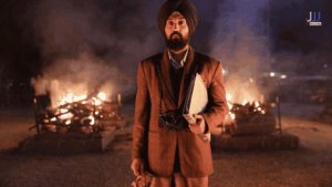 Download Satluj movie scene, Diljit Dosanjh holding camera and files near burning pyres