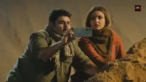 Reporting Live cast Deven Bhojani and Adil Hussain in the newsroom scene